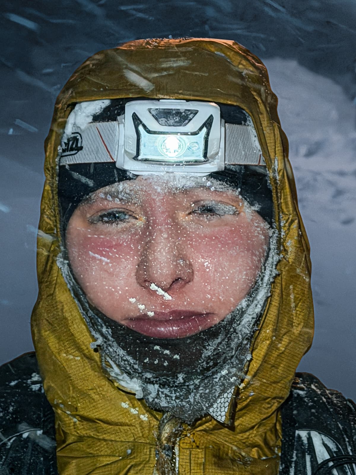 Portrait of runner Nina covered in frost with a headlamp