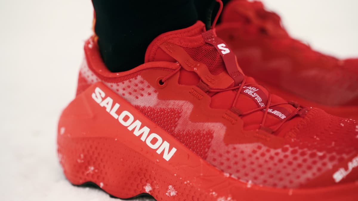Close-up of a red Salomon trail running shoe in the snow